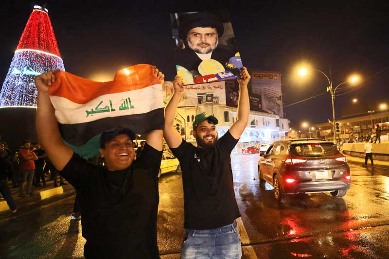 upporters of Iraqi Shiite cleric Moqtada al-Sadr celebrate in Baghdad's Tahrir square on October 11, 2021 following the announcement of parliamentary elections' results.
