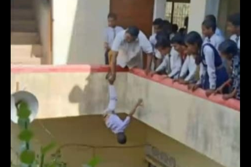 UP: Principal hangs kid upside down from building