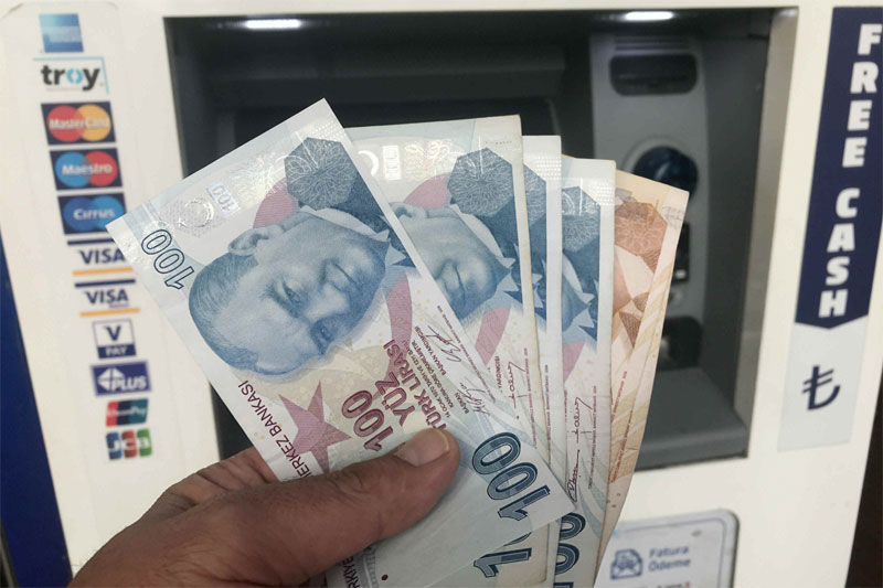 Turkey further cuts rates, lira dips to new record low