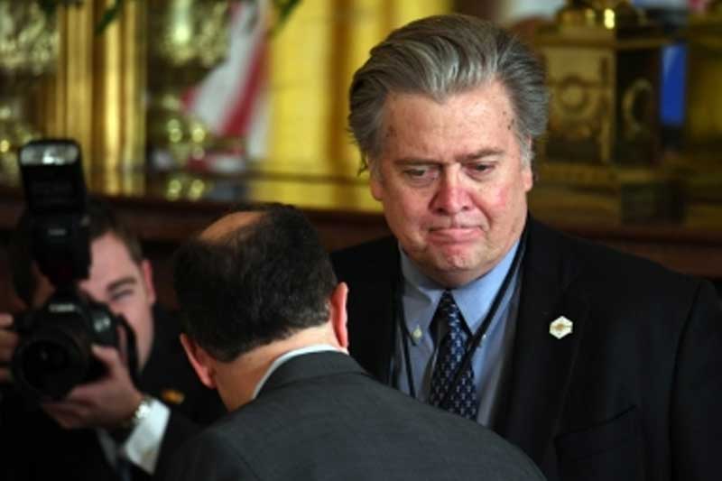 Ex-Trump adviser charged after surrendering to prosecutors