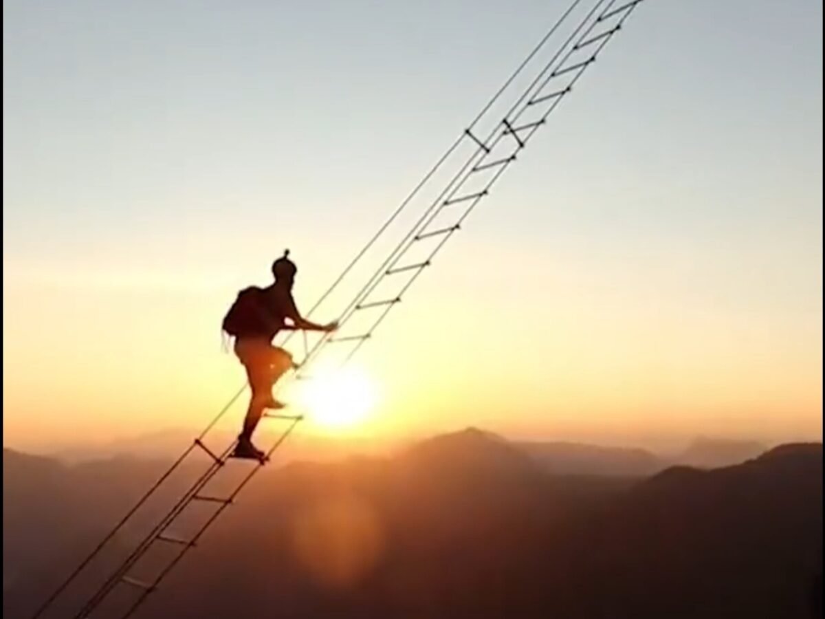 Jaw-dropping snaps show thrill-seeker on 2,300ft mountain ladder