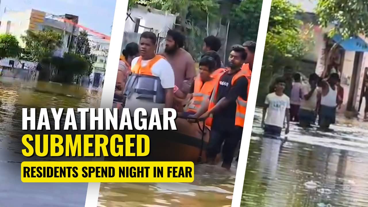 GHMC officials and residents wading through the flooded streets of Banjara Colony in Hayathnagar after heavy rainfall on Sunday night.
