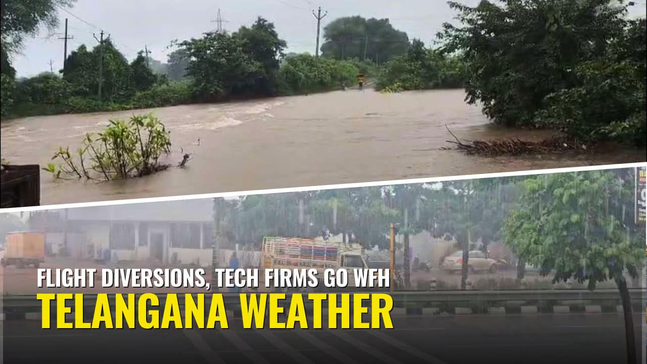 Traffic moves slowly on a waterlogged street in Hyderabad during heavy rainfall on September 26, 2025.