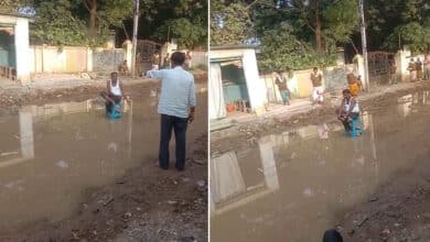 Salon Owner Blocks Waterlogged Road, Protests Slow Repairs Affecting His Business